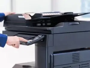 Office-professional-operating-photocopier-controls